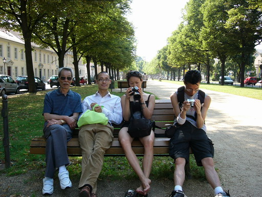 family relaxing in potsdam city park